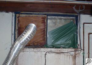 A basement window system that's rotted and  has been damaged over time in Wethersfield.